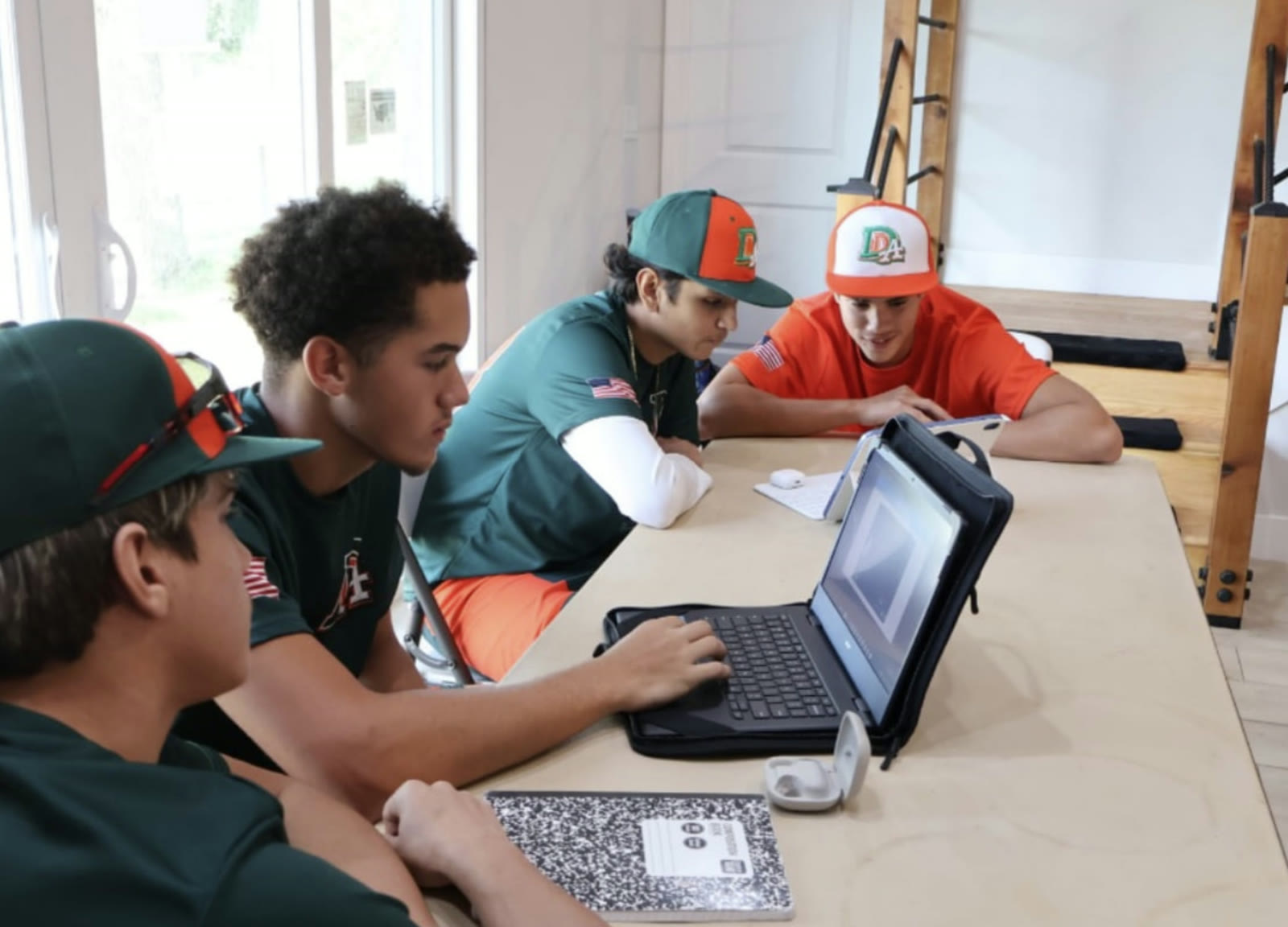 DDLA athletes working on laptops in the study room